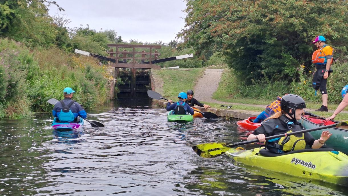 People kayaking on a canal